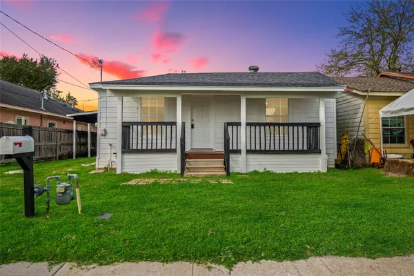 a view of a house with a yard and porch