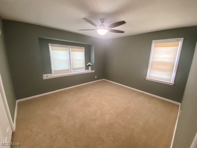 5384 Huron Road Cleveland, OH 44124 - Photo 11 of 20 Large bedroom featuring ceiling fan, window shades, and light carpet
