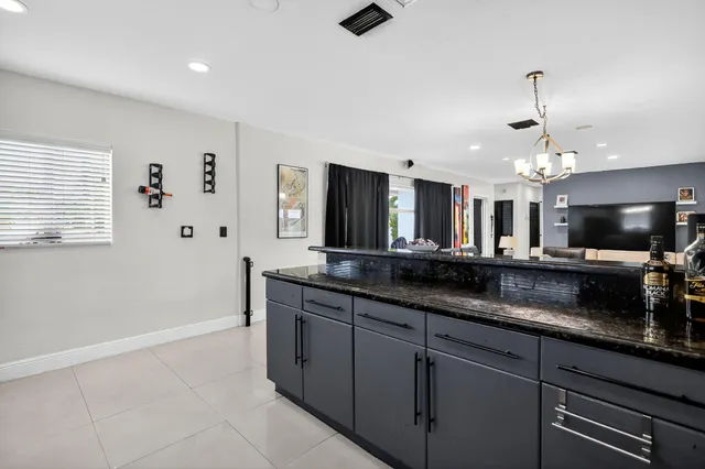 a living room with furniture kitchen view and a dining table