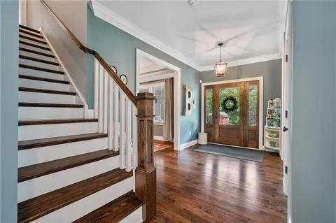 a view of entryway and hall with wooden floor