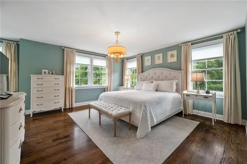 a bedroom with a large bed and a window