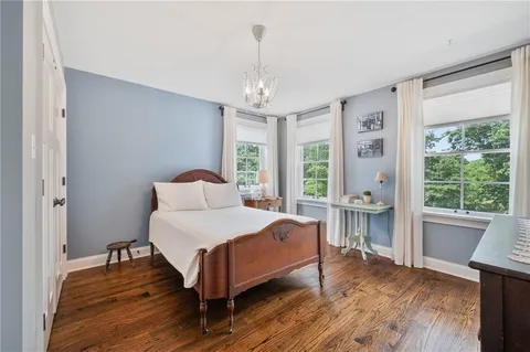 a bedroom with a bed and a table chair