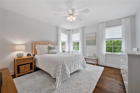a bedroom with a large bed and a chandelier