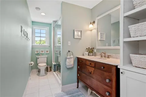 a spacious bathroom with a granite countertop sink toilet and shower
