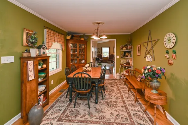a view of a dining room with furniture and chandelier