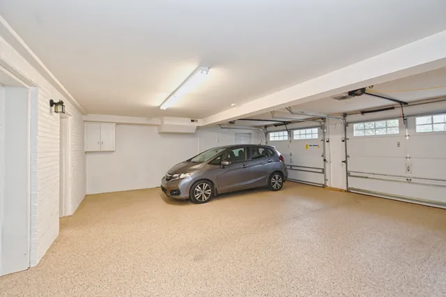 a view of parking garage with cars parked