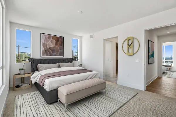 a bedroom with a large bed and a chandelier