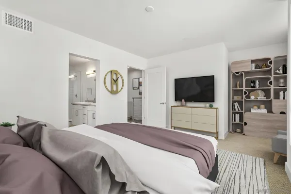 a bedroom with a bed and a flat screen tv