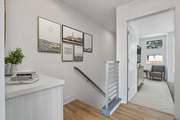 a view of a hallway to a livingroom and a couch