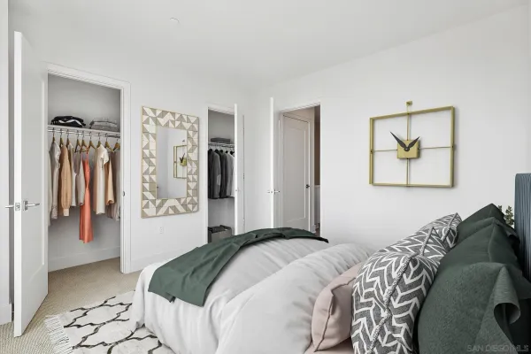 a bedroom with a bed and a painting on the wall