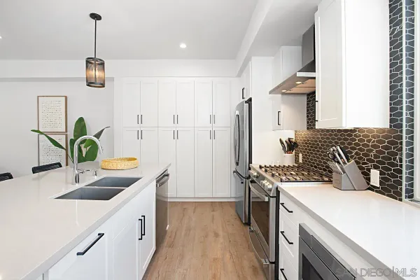 a kitchen with a sink stove and refrigerator