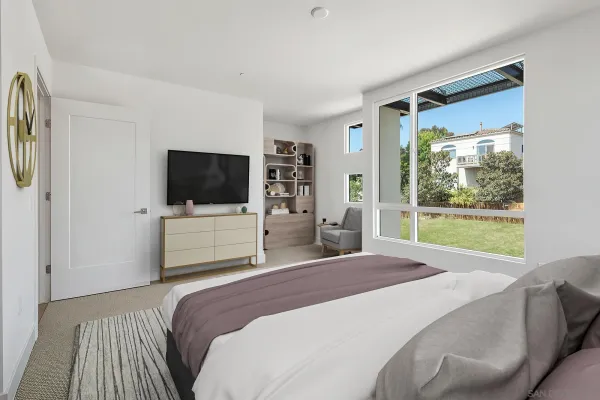 a bedroom with a large bed and a flat tv screen on dresser