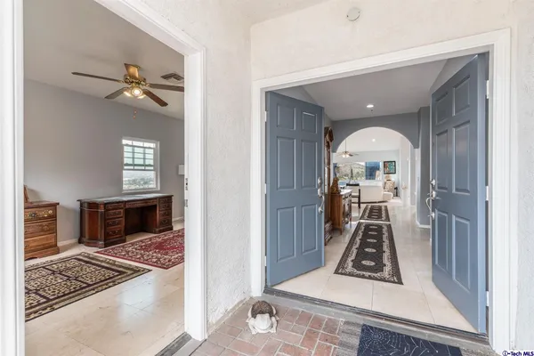 a living room with hard wood flooring and a rug