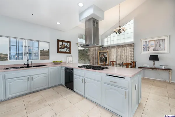 a large white kitchen with cabinets