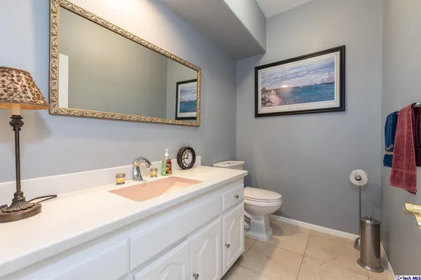 a bathroom with a sink a toilet and mirror