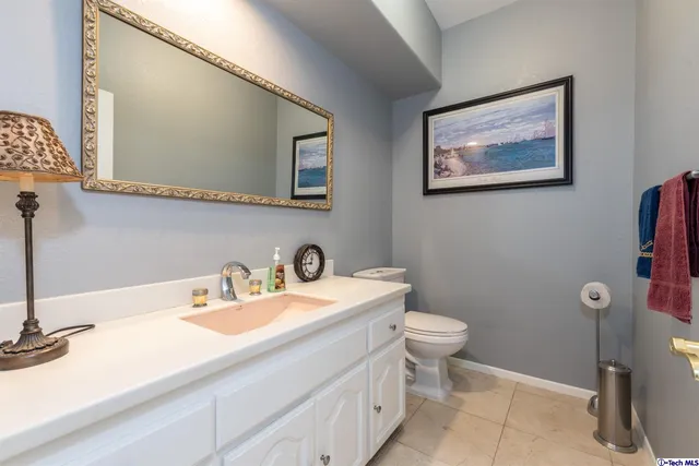 a bathroom with a sink a toilet and mirror