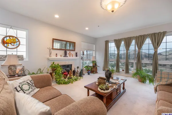 a living room with furniture and a floor to ceiling window