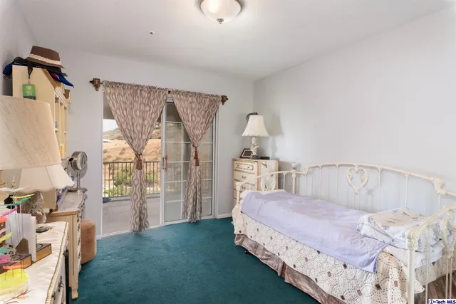 a spacious bedroom with a bed and a window