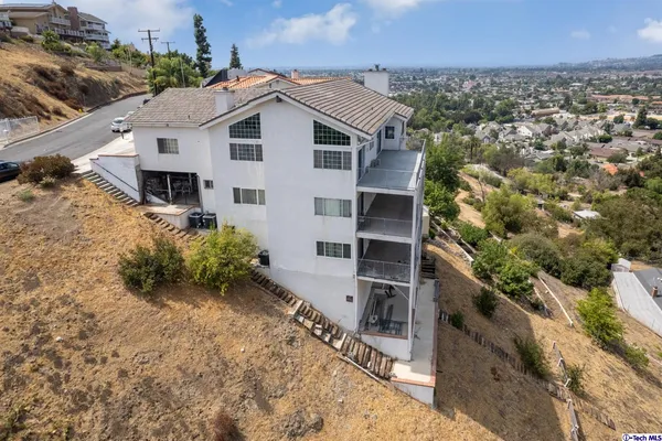 an aerial view of a house with a yard