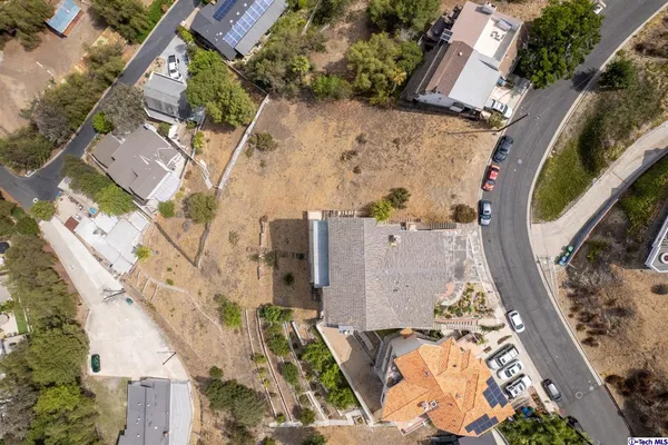 an aerial view of a house with a yard