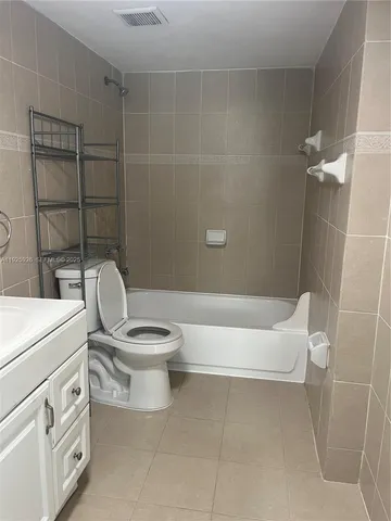 a white toilet sitting next to a bathroom sink