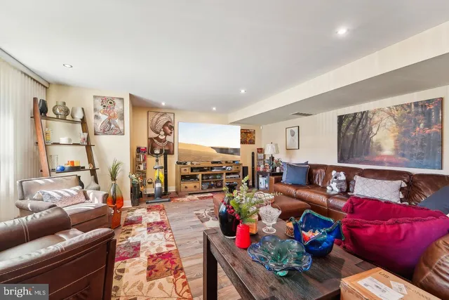 a living room with furniture and a floor to ceiling window