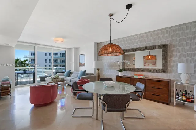 a living room with furniture a rug and a chandelier