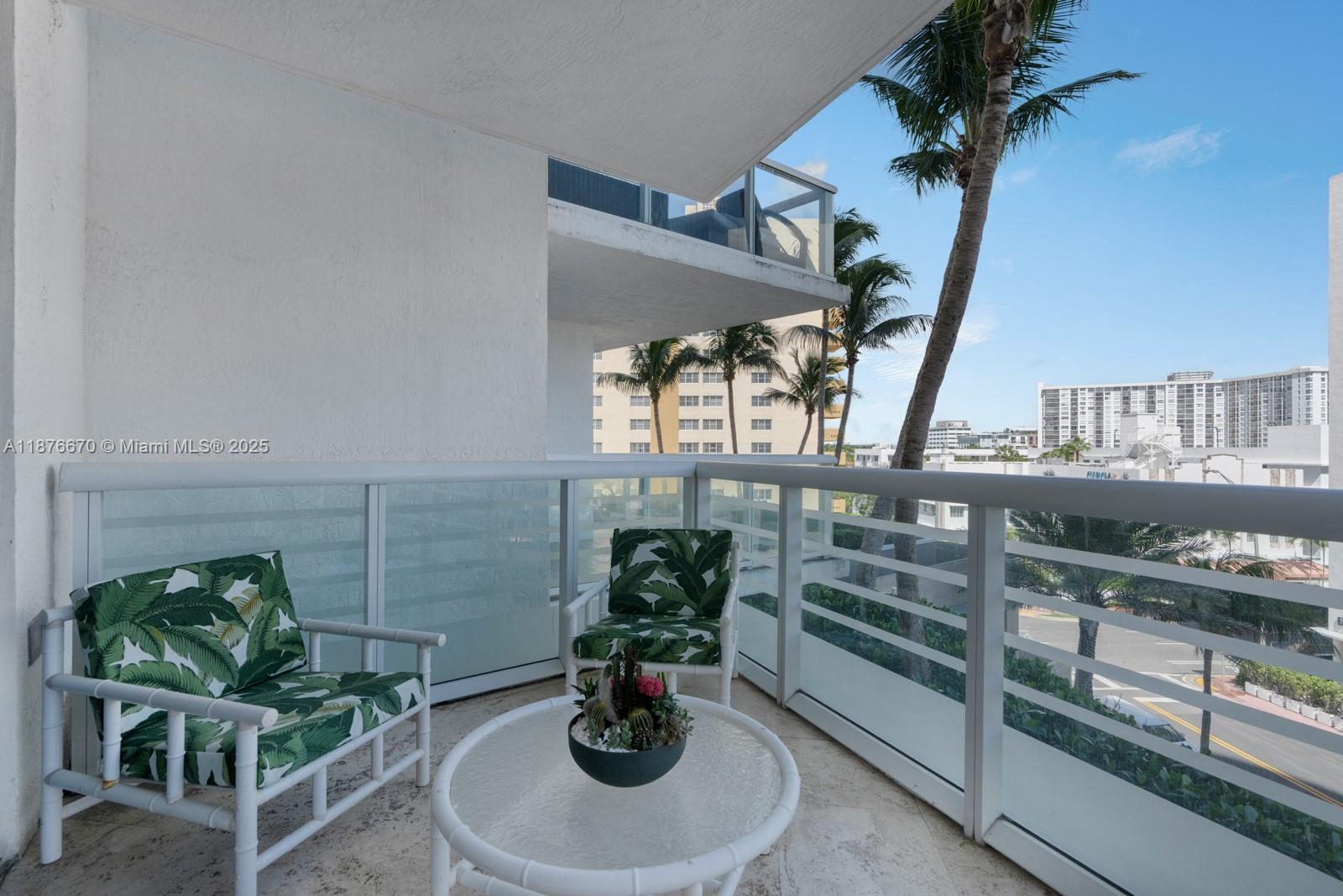 3801 Collins Avenue, Unit 503 Miami Beach, FL 33140 - Photo 18 of 31 a dining room with furniture potted plants and wooden floor