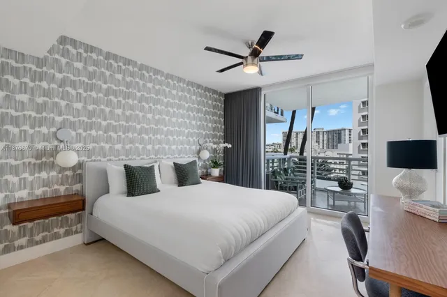 a bedroom with a large bed and a flat tv screen