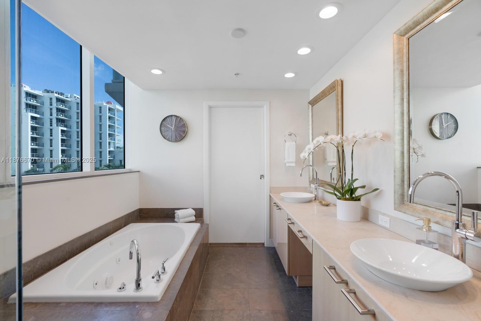 3801 Collins Avenue, Unit 503 Miami Beach, FL 33140 - Photo 5 of 31 a bathroom with a double vanity sink mirror and bathtub