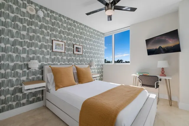 a bed room with a bed and a television