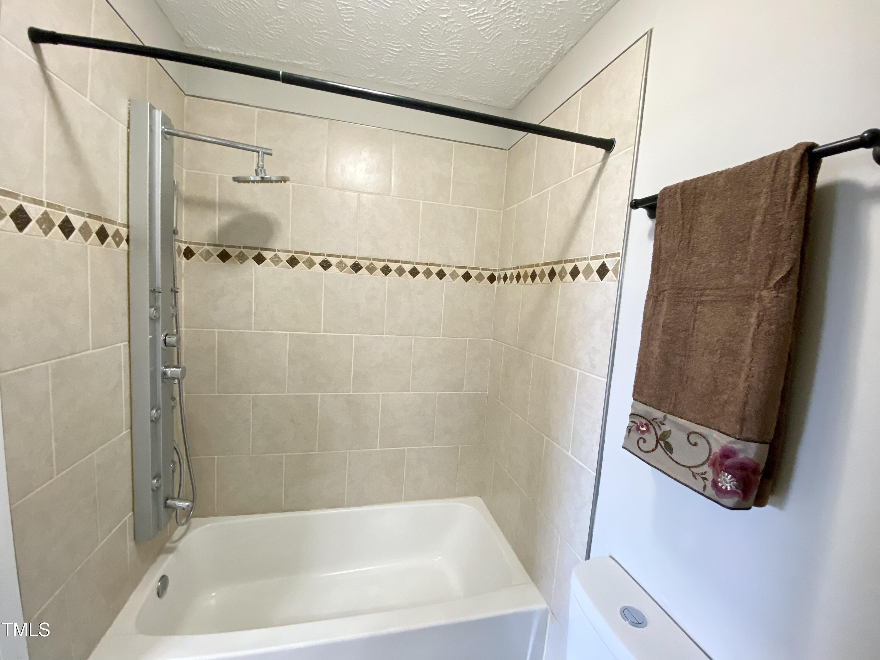 9785 Rockfish Road Raeford, NC 28376 - Photo 14 of 27 a bathroom with a shower and a tub