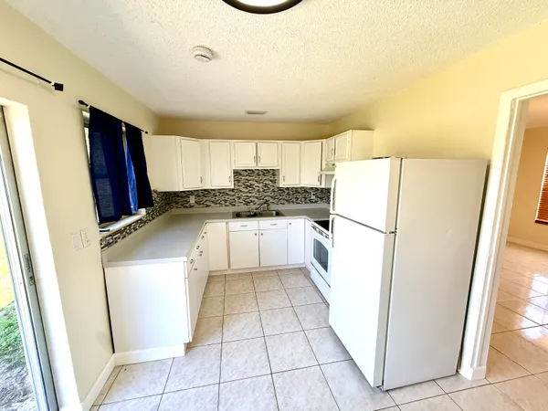 a kitchen with a refrigerator a sink and dishwasher