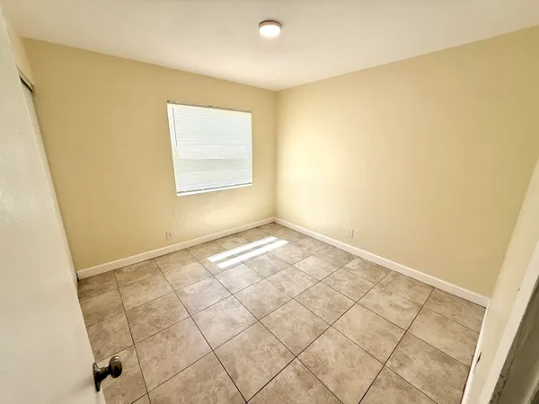 a view of an empty room and a window