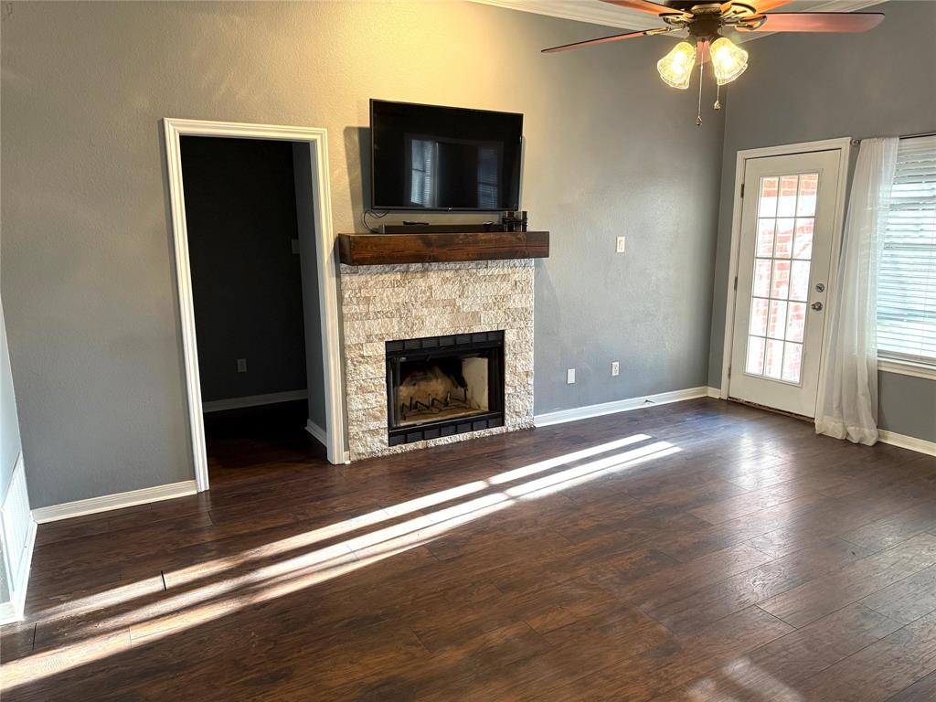 921 Cloud Croft Drive Hewitt, TX 76643 - Photo 2 of 18 a view of an empty room with wooden floor and a fireplace