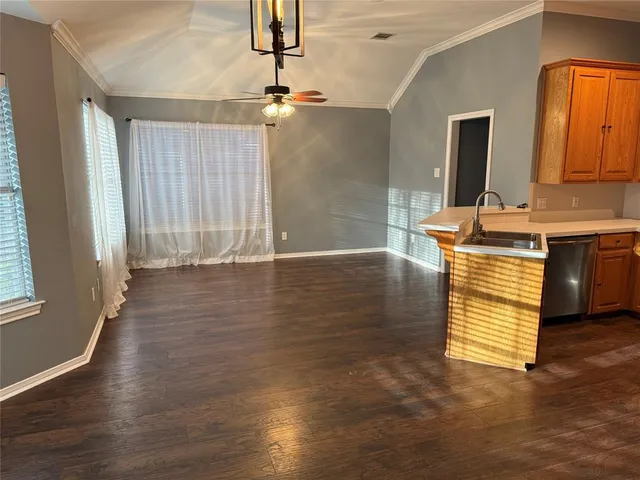 a view of a kitchen with wooden floor and staircase