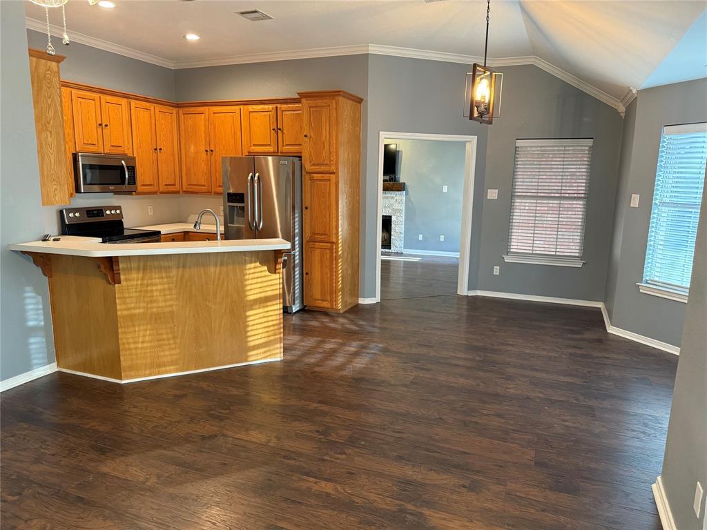 921 Cloud Croft Drive Hewitt, TX 76643 - Photo 6 of 18 a kitchen with stainless steel appliances granite countertop a refrigerator a sink dishwasher a stove and a microwave oven with wooden floor