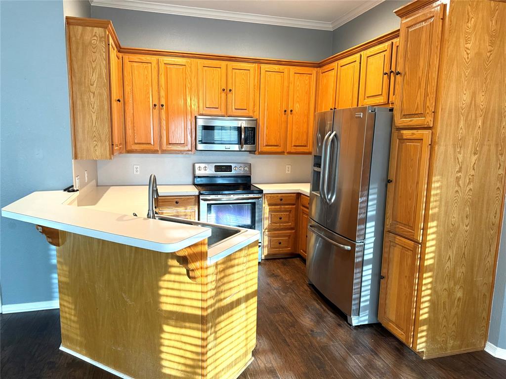 921 Cloud Croft Drive Hewitt, TX 76643 - Photo 8 of 18 a kitchen with stainless steel appliances a refrigerator sink and cabinets
