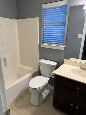 a bathroom with a sink a toilet and bathtub