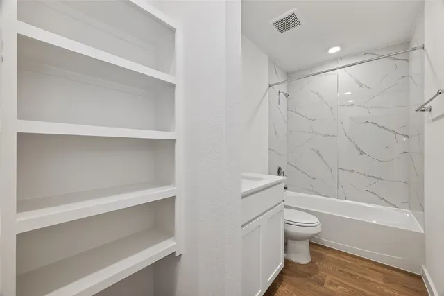 a bathroom with a toilet and a bathtub