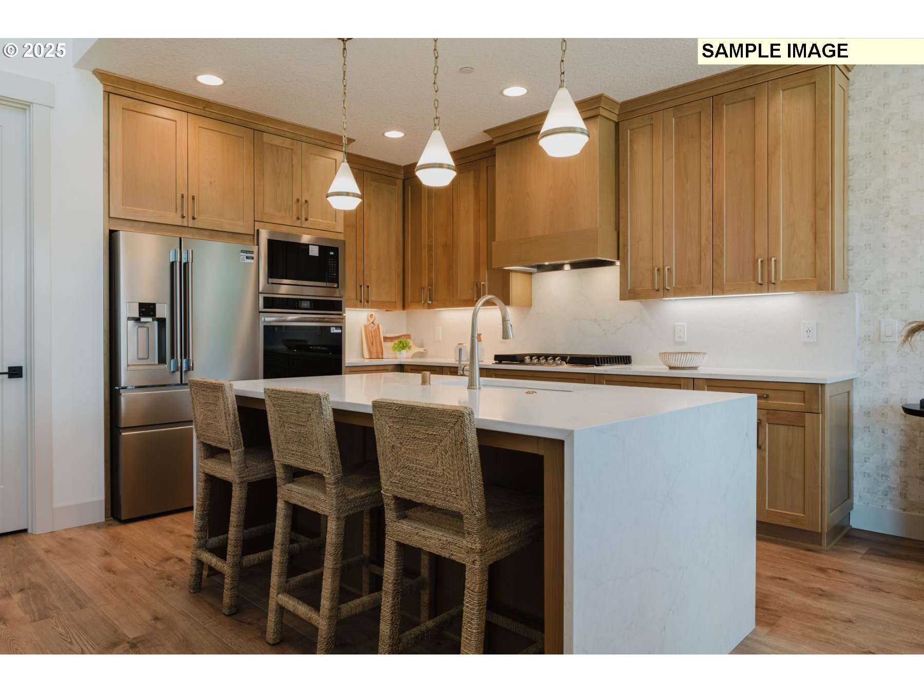 4715 Northwest Camas Meadows Drive Camas, WA 98607 - Photo 9 of 21 a kitchen with kitchen island granite countertop a refrigerator a stove a sink and white cabinets with wooden floor