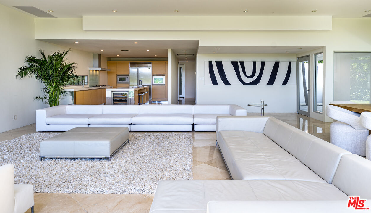 1466 Bel Air Road Los Angeles, CA 90077 - Photo 13 of 35 a living room with furniture and a potted plant