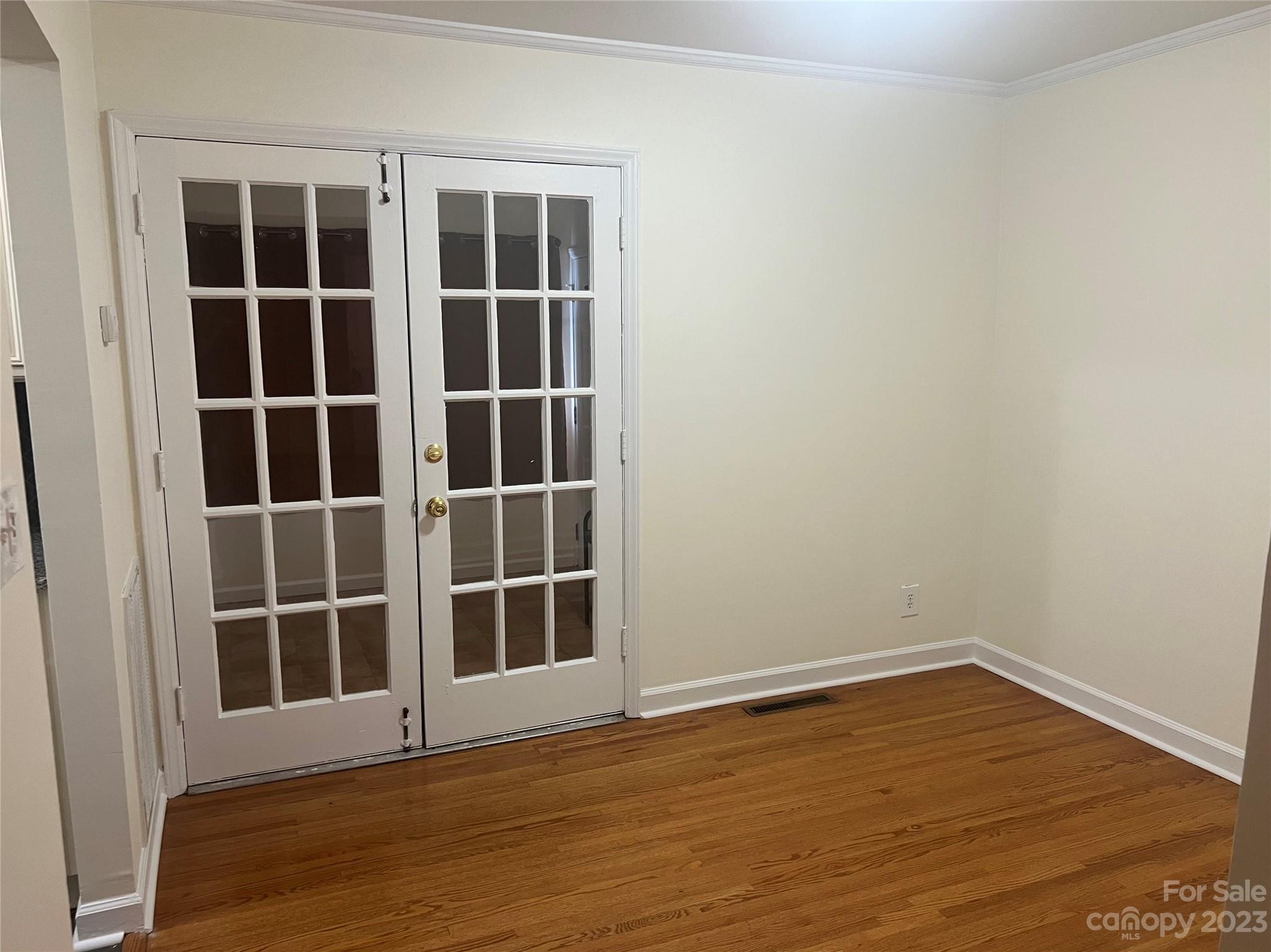 908 McAlway Road Charlotte, NC 28211 - Photo 5 of 13 a view of empty room with wooden floor and windows
