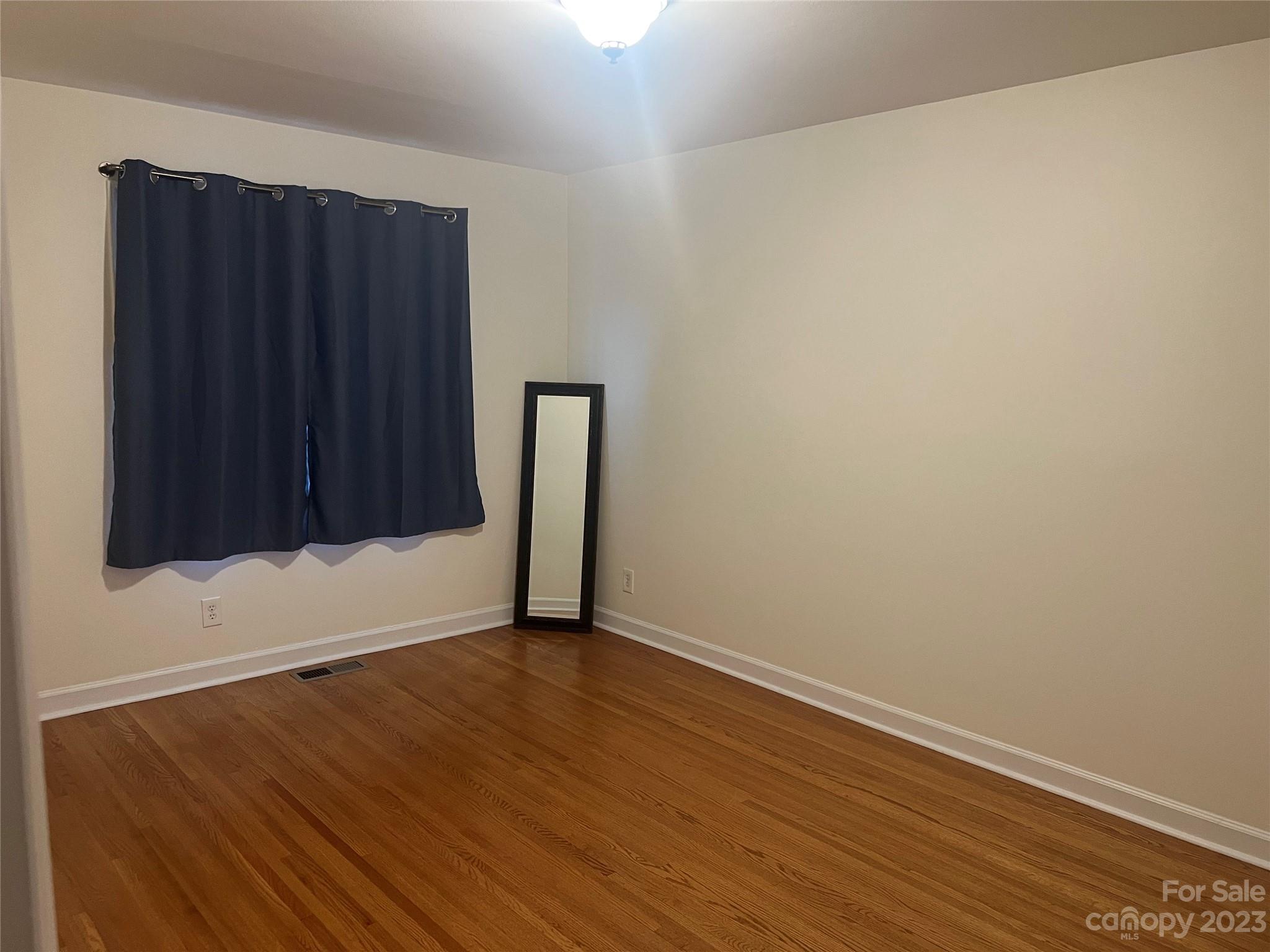908 McAlway Road Charlotte, NC 28211 - Photo 9 of 13 a view of an empty room with wooden floor