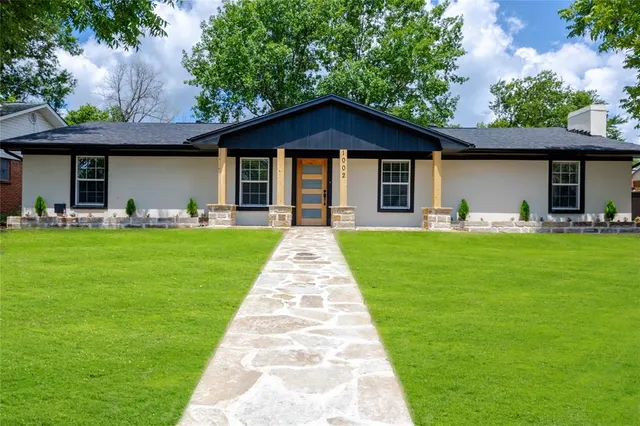 a front view of house with yard and green space