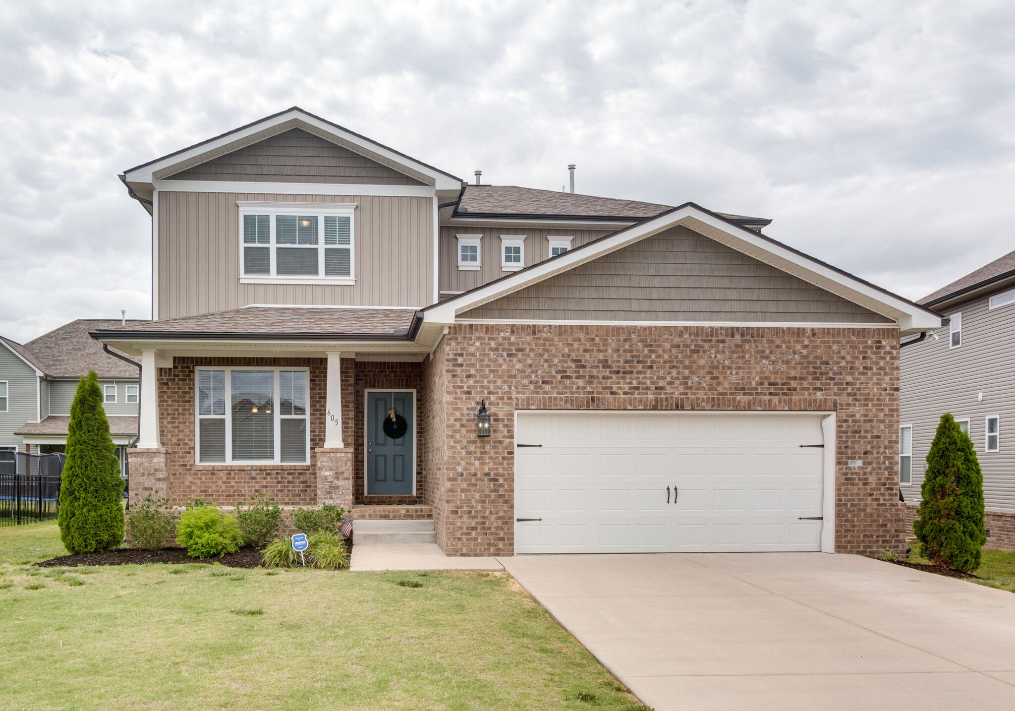 a front view of a house with a garden