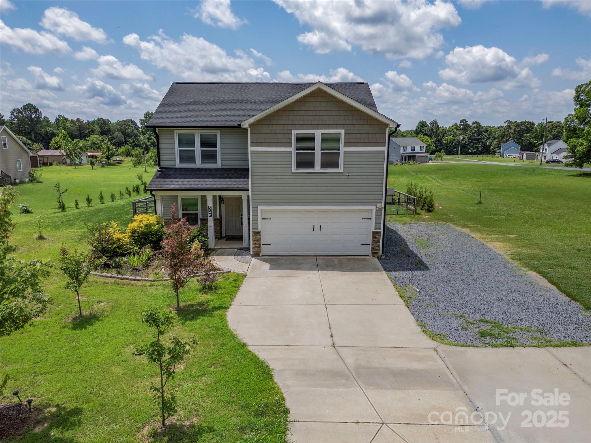 a front view of house with yard and green space