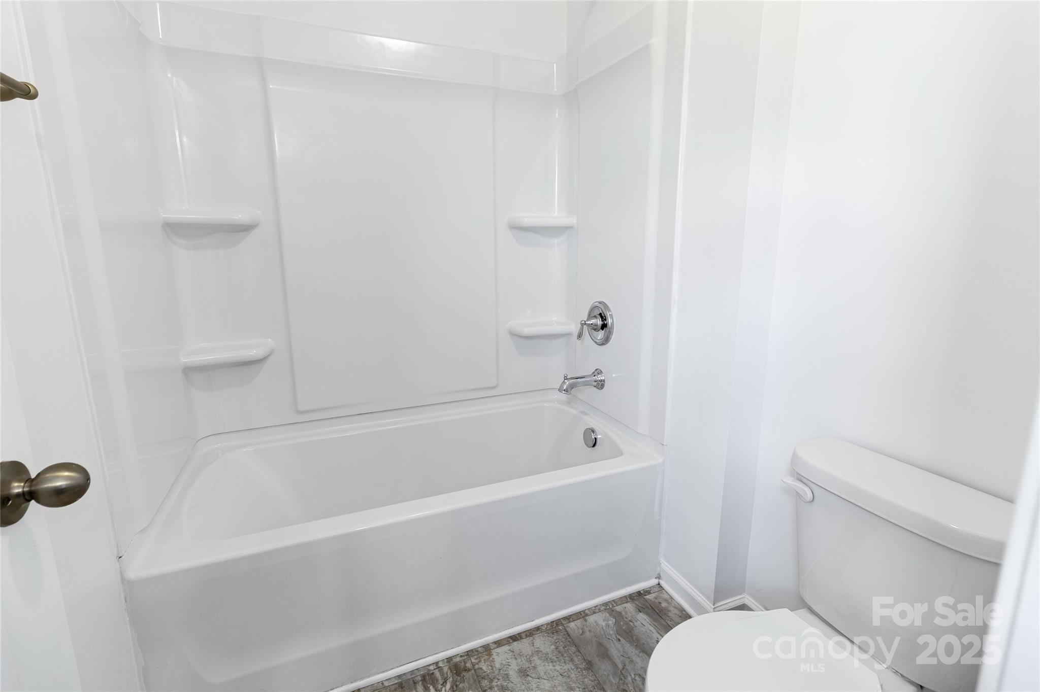 556 Big Lick Road Stanfield, NC 28163 - Photo 11 of 19 a bathroom with a toilet and a bathtub