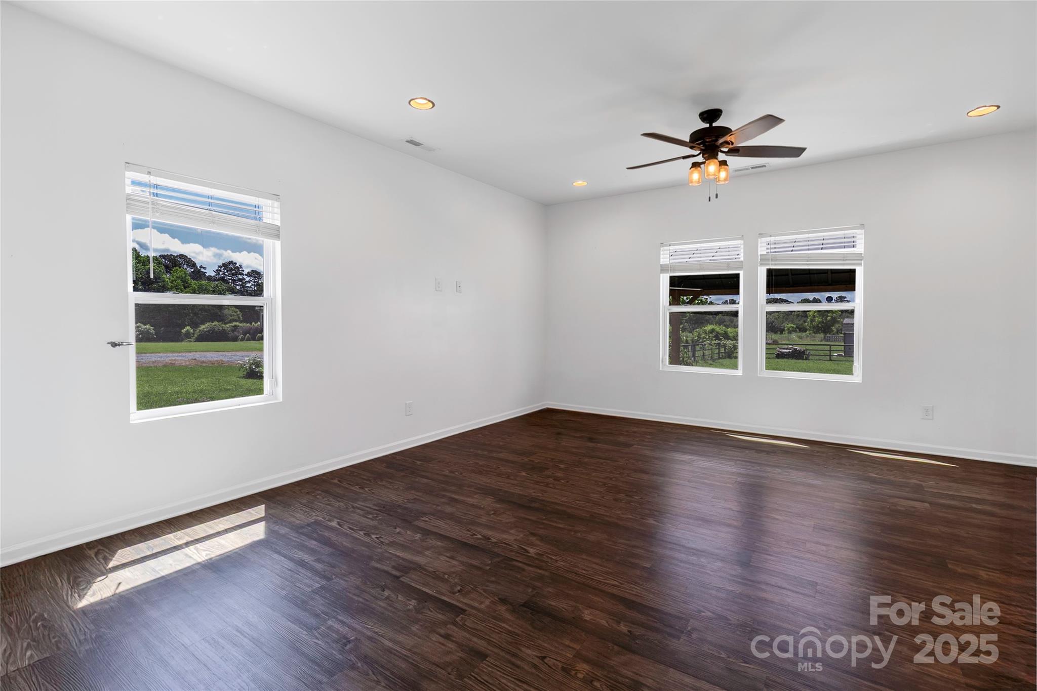 556 Big Lick Road Stanfield, NC 28163 - Photo 2 of 19 a view of empty room with wooden floor and fan