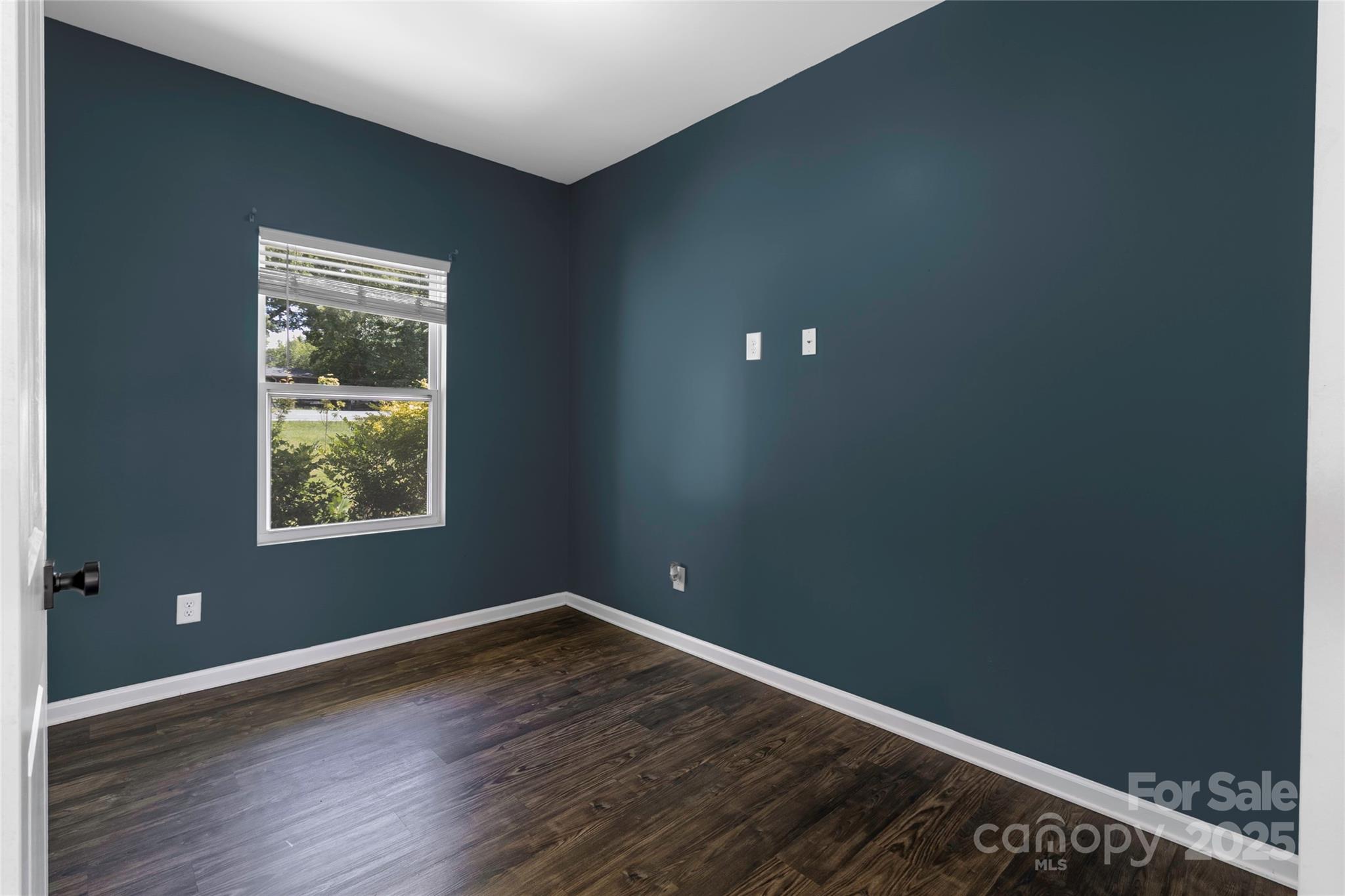 556 Big Lick Road Stanfield, NC 28163 - Photo 3 of 19 a view of an empty room with wooden floor and a window